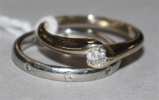 A platinum and diamond wedding ring and a diamond solitaire ring, 18ct gold setting.